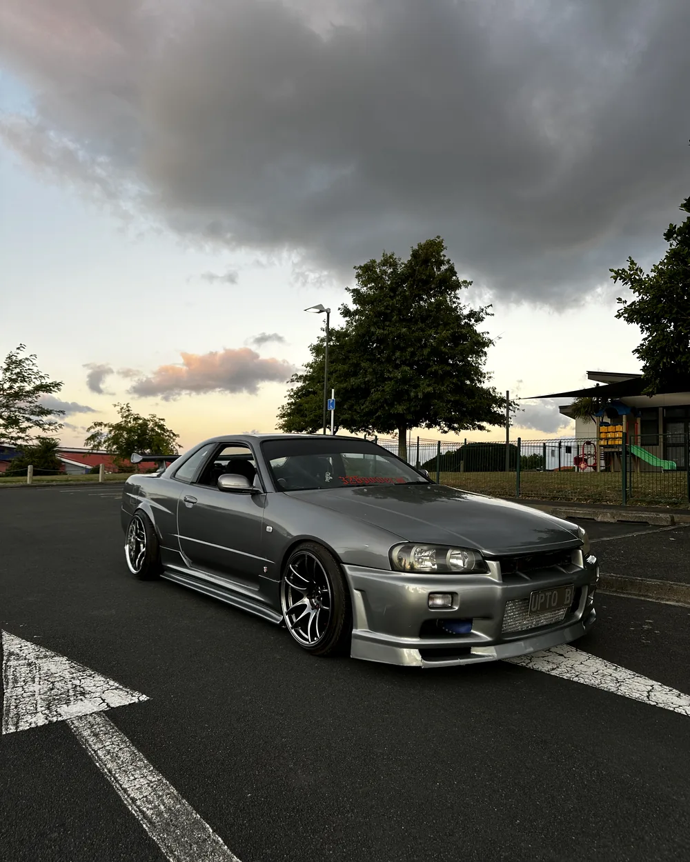 Nissan Skyline R34 front three quarter, lowered on staggered wheels